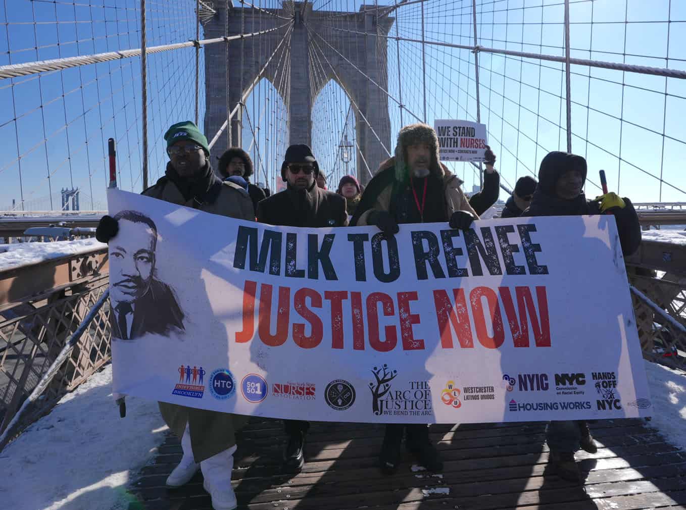 Anti-ICE protesters march across Brooklyn Bridge in New York City
