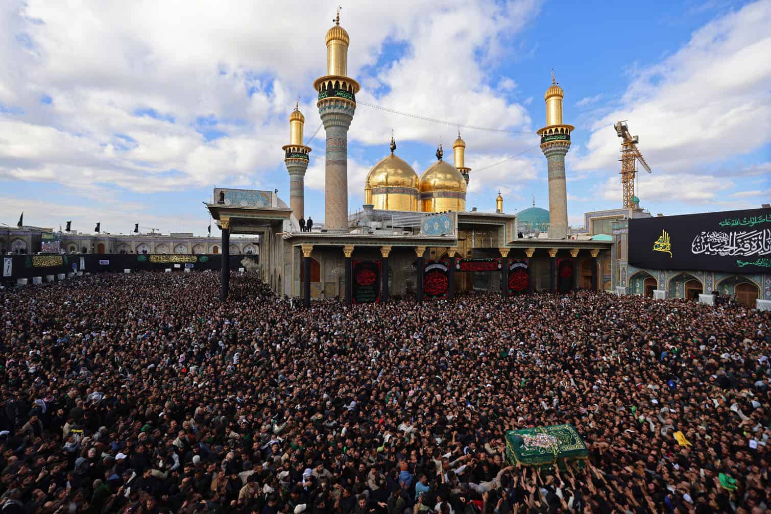 Shiite Muslim pilgrims march with a symbolic coffin