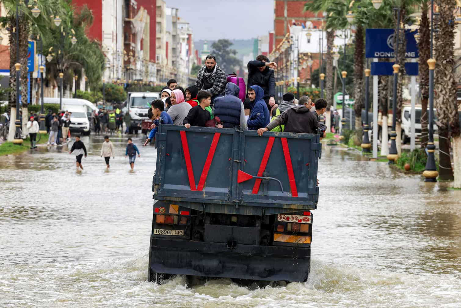 People ride in the back of a truck