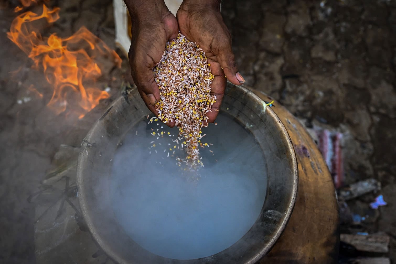 A priest cooks a rice dish