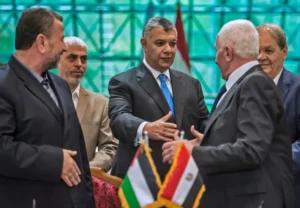 hamas_and_fatah_leaders_shake_hands_following_the_signing_of_a_reconciliation_deal_at_the_egyptian_intelligence_services_headquarters_in_cairo_in_october_2017._afp.jpg-e1760942804460.webp