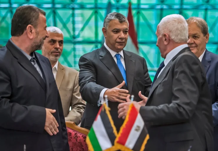 hamas_and_fatah_leaders_shake_hands_following_the_signing_of_a_reconciliation_deal_at_the_egyptian_intelligence_services_headquarters_in_cairo_in_october_2017._afp.jpg-e1760942804460.webp