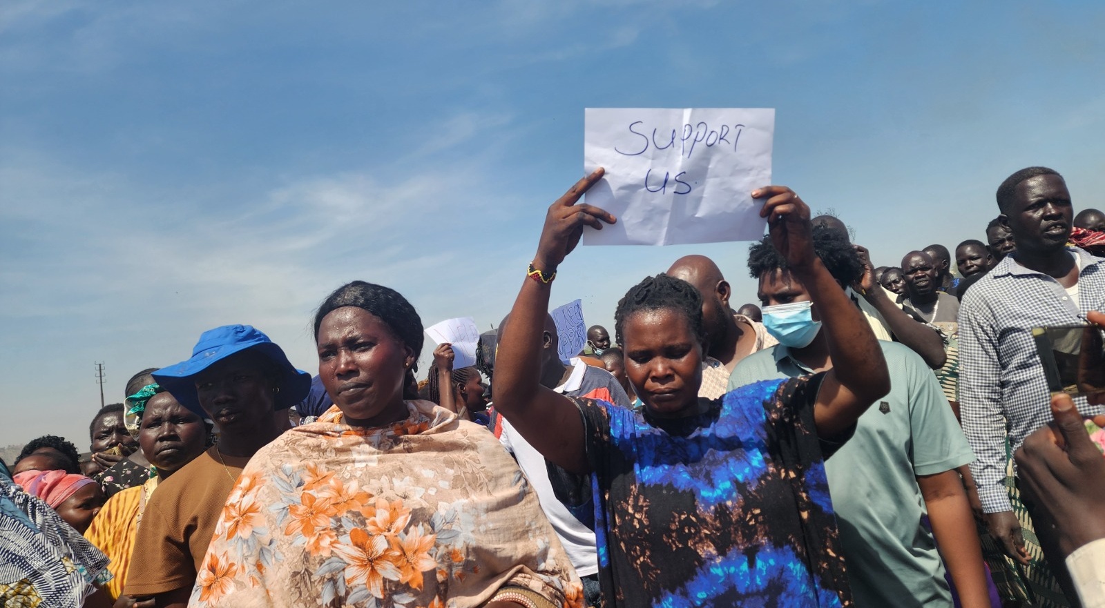 Businesseswomen affected by Custom fire hold help-us sign , on Thursday, December 4, 2025. [Photo by Sudans Post]