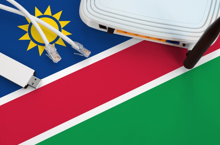 namibia-flag-depicted-on-table-with-internet-rj45-cable-wireless-usb-wi-fi-adapter-and-router-e1769700333577.jpg